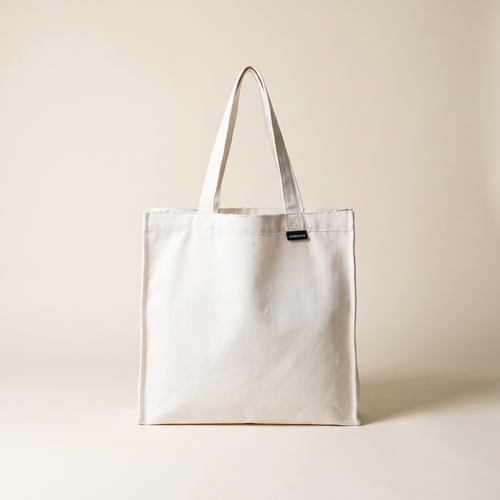 Raw Edge Tote in white canvas with OVERSIZED wordmark tag